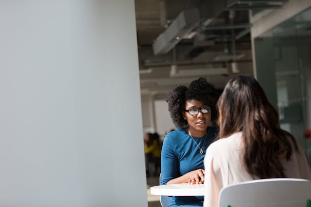 two people talking at a table